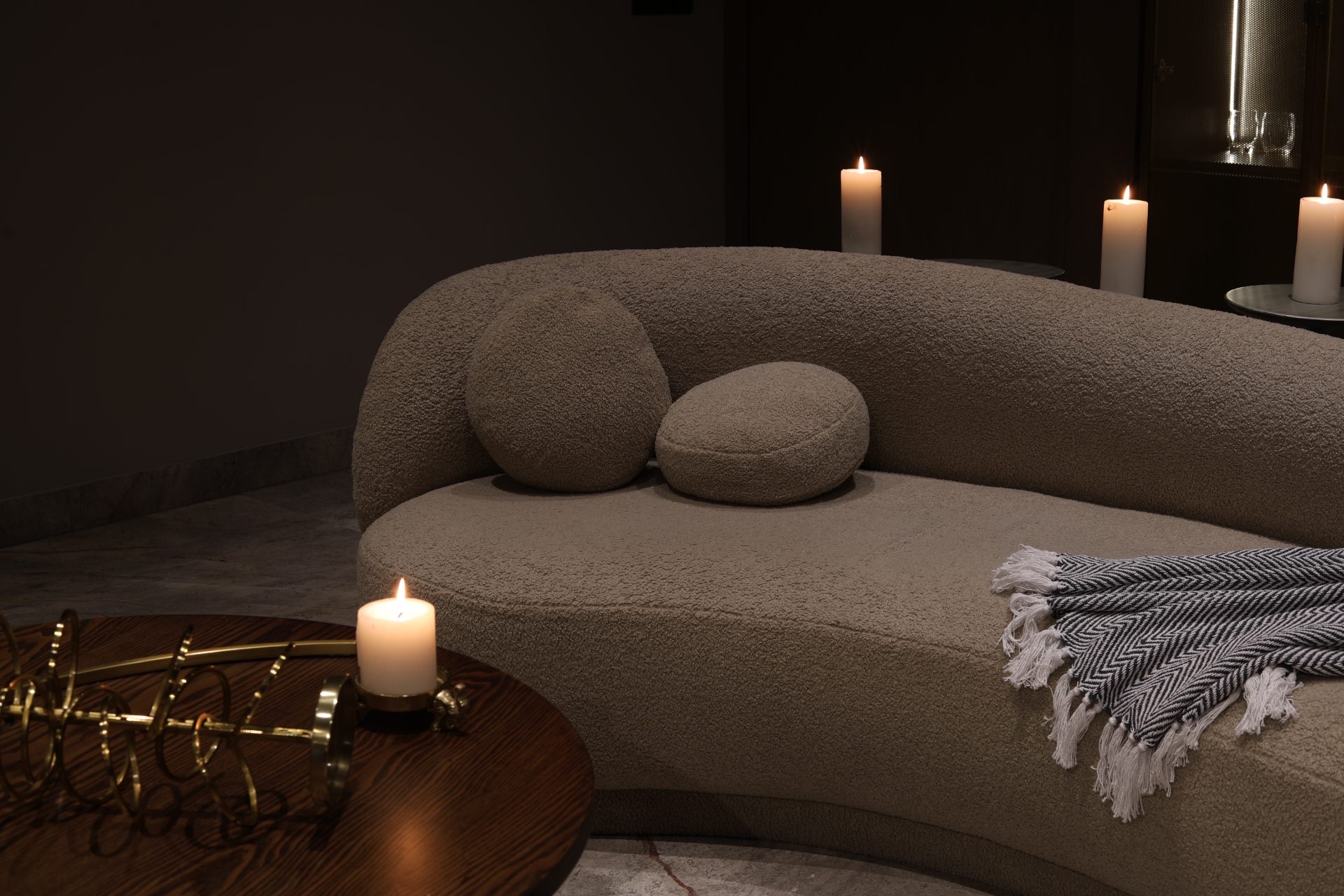 Bouclé sofa by candlelight